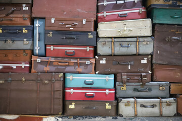 Stack of colorful vintage suitcases. Retro decorative suitcases, new vacation plans and journeys. old style suitcases stacked on top of each other