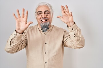 Middle age man with grey hair standing over isolated background showing and pointing up with...