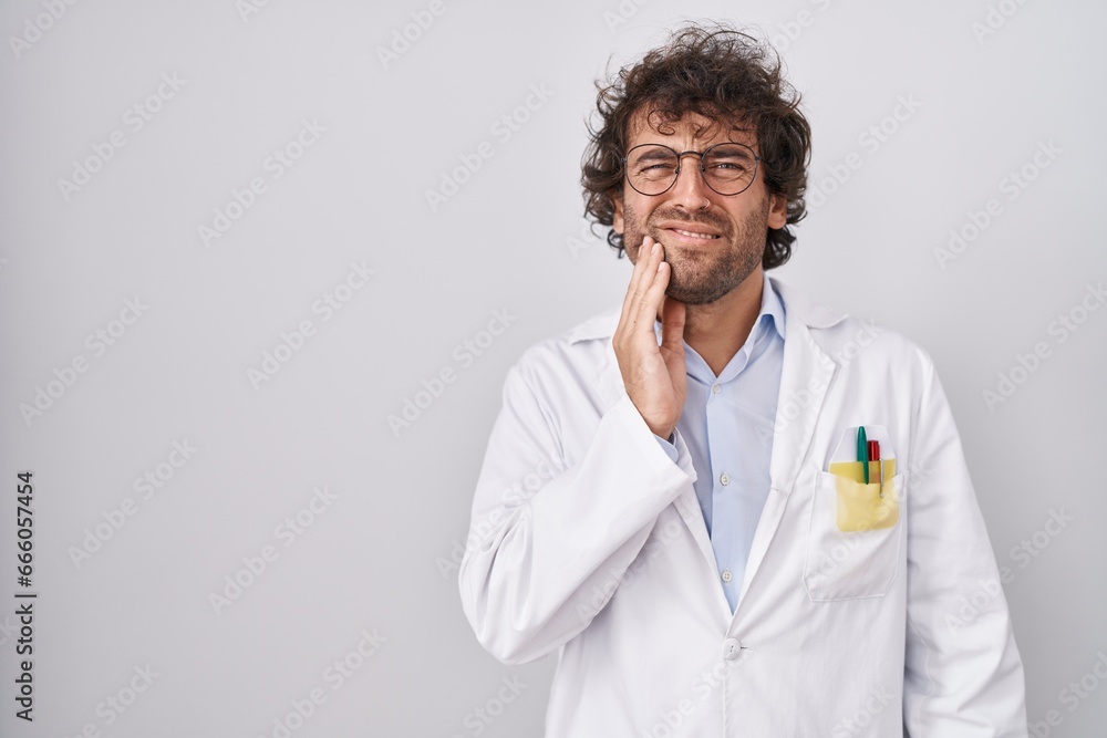 Wall mural hispanic young man wearing doctor uniform touching mouth with hand with painful expression because o