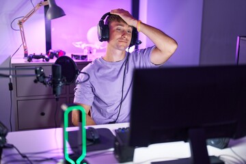 Young caucasian man streamer stressed using computer at gaming room
