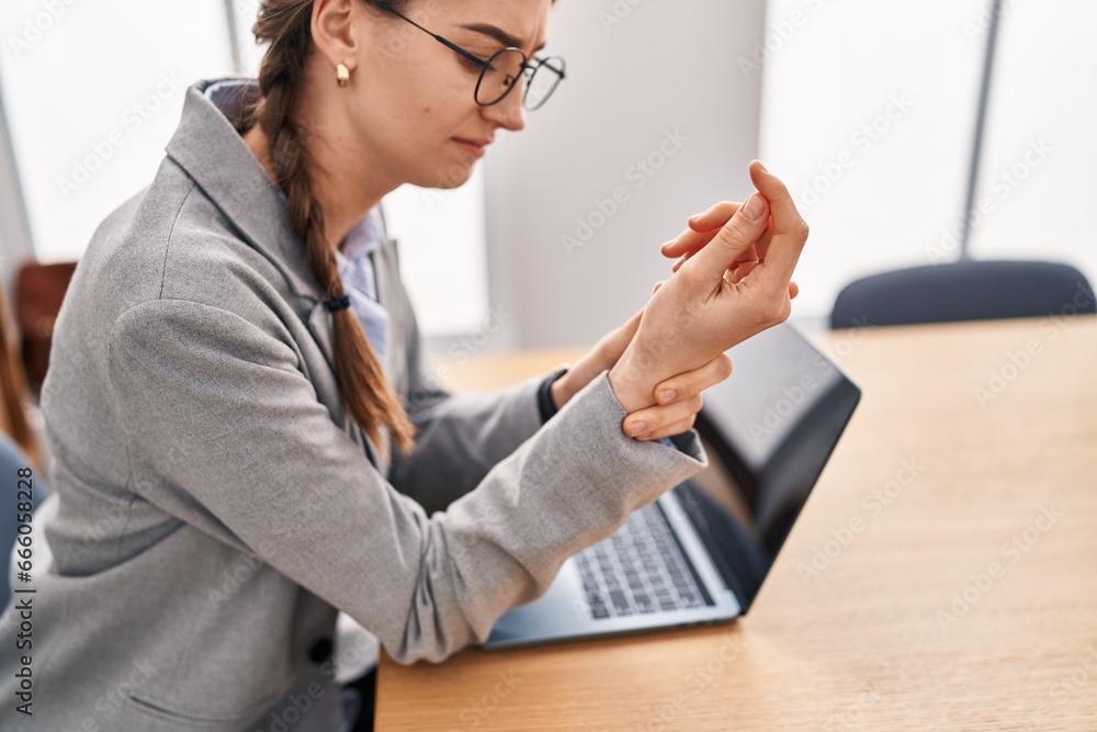 Sticker young caucasian woman business worker using laptop suffering for wrist pain at office