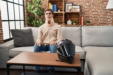 Young man wearing cervical collar for motorbike accident with serious expression on face. simple and natural looking at the camera.