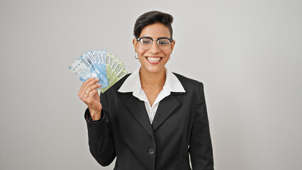 Young beautiful hispanic woman business worker holding chilean pesos smiling over isolated white...