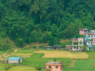 Fototapeta na wymiar Aerial view of a nepalese rural landscape near Lake Bagnes, rice fields and houses, agricultural work. Lekhnath, Pokhara. Nepal