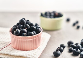  Delicious group of blueberries on ceramic bowls marble surface