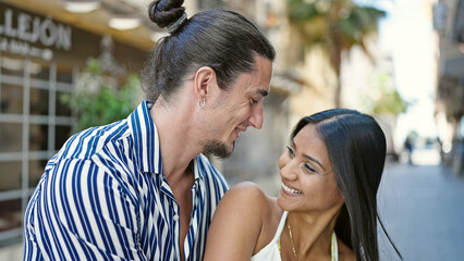 Man and woman couple smiling confident standing together at street