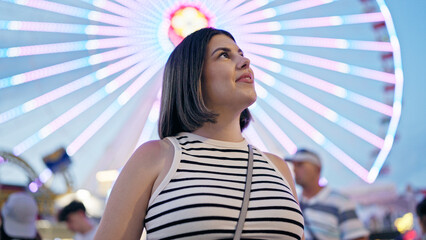 Young beautiful hispanic woman smiling looking around at Prater Vienna