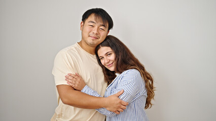 Fototapeta premium Man and woman couple smiling confident hugging each other over isolated white background