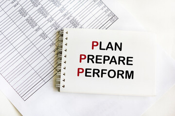 PLAN PREPARE PERFORM text on notepad and white background