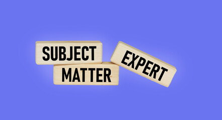 On a blue background, wooden blocks with the text SUBJECT MATTER EXPERT