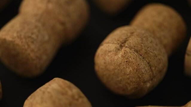 Wine corks lying on a black background.