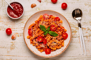 Homemade pasta with tomato sauce, top view.