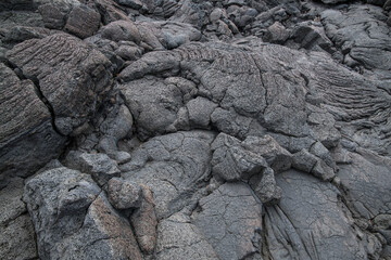 Cooled lava / Background of cooled lava with cracks and crevices. - 666083202