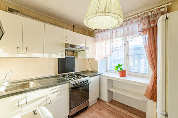 Fototapeta na wymiar interior apartment kitchen and dining room, refectory area, cooking equipment, table furniture, stove