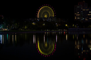 THE SUN OF MOSCOW. Ferris Wheel in Moscow. View from Ostankino pond.Night.