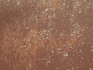Rusted metallic background, texture. An old red and rusty surface with faded uneven color. Abstract rust pattern on light-brown metal surface. Backdrop with peeling burgundy paint and blooming mold