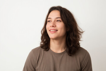 Fototapeta premium Everyday people. A smiling man with long hair. Wearing a brown shirt. On a white background. Friendly man. Clean shaven. Baby face. Portrait.