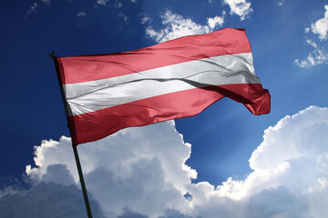 national flag of Austria waving in the wind on a clear day.
