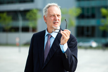 Mature thoughtful businessman portrait outdoor