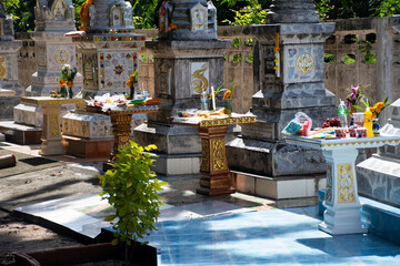 Thai people family ritual offering sacrifice food to ancestor at graveyard urn in festival of Tenth...
