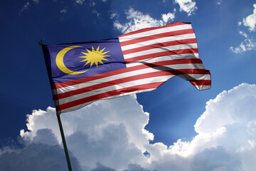 national flag of Malaysia waving in the wind on a clear day.