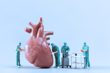 Miniature People Doctor checking and analysis heart model , Science and medicine concept