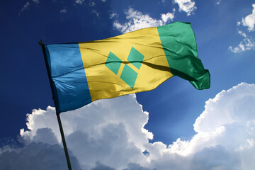 national flag of Saint Vincent and The Grenadines waving in the wind on a clear day.