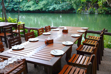 The set table for lunch or dinner nearby the garden and lake