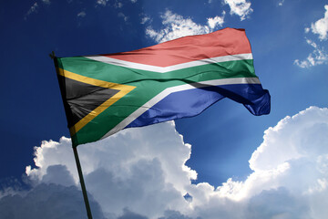 national flag of South Africa waving in the wind on a clear day.
