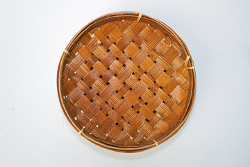 Traditional woven plate made of bamboo or woven bamboo plate basket isolated on white background.