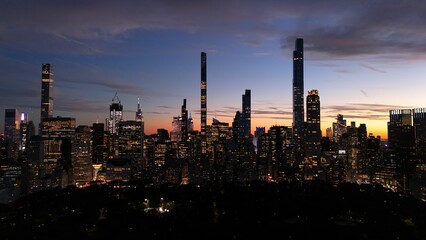 a view of a city skyline at night as the sun sets