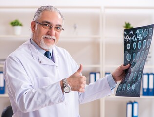 Aged male doctor radiologist in the clinic