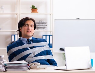 Young tied male employee in the office