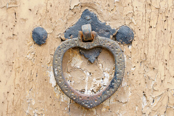 Vintage old door handle on a wooden door.