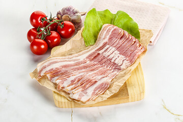 Sliced pork bacon oved board