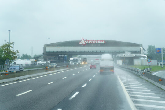 Autogrill restaurant and bar on a cloudy rainy day with gloomy skies on a motorway in Italy.