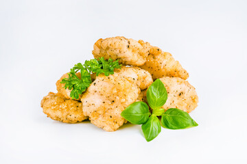 Fast homemade food at home. Breaded chicken nuggets.Breaded Chicken Inner Fillet with green lettuce leaves on a White Background.Chicken Breaded Raw Meat,Fillet.Chicken breaded schnitzels.Fast cooking