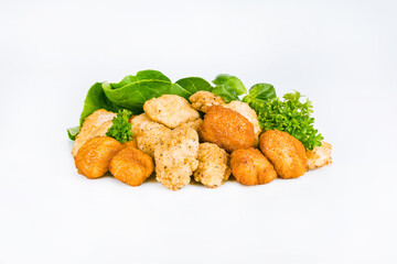 Breaded chicken nuggets.Breaded Chicken Inner Fillet with green lettuce leaves on a White Background.Chicken Breaded Raw Meat,Fillet.Fast homemade food at home. Chicken breaded schnitzels.Fast cooking