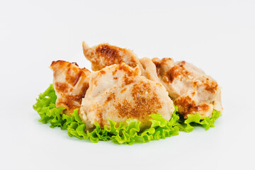 Chicken fillets fried until half cooked, semi-finished product with fresh herbs on a white background. Fast cooking.Fast homemade food.Fast food. Quick cooking at home. Copy space.