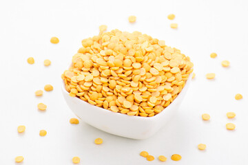 Uncooked chana dal in bowl on white background