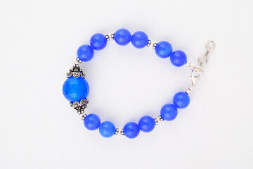 Top view of blue stone bracelet on white background