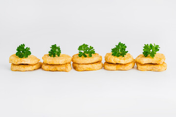 Chicken Breaded Fillet.Fast food. Breaded Chicken Inner Fillet on a White Background,Chicken Breaded Raw Meat. Fast cooking. Breaded chicken nuggets. Homemade food at home.