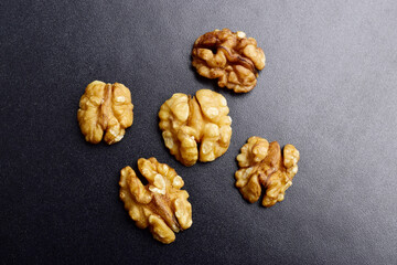 Top view of walnut seeds on dark background