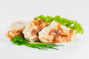 Chicken fillets fried until half cooked, semi-finished product with fresh herbs on a white background. Fast cooking.Fast homemade food.Fast food. Quick cooking at home. Copy space.