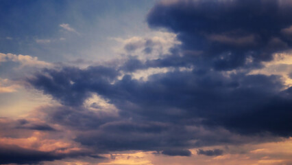 Cumulus clouds in the sky at sunset. Dramatic sky.