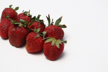 
Some fresh ripe red strawberries have green leaf petals.