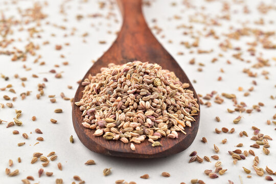 Closeup of carom seeds in wooden spoon
