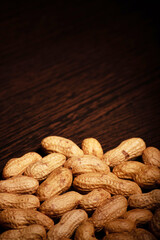 Vertical view of roasted peanut on table with text space