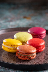 Delicious macaroons on the table. Macarons cakes in different colors.