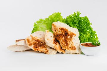 Chicken fillets fried until half cooked, semi-finished product with fresh herbs on a white background. Fast cooking.Fast homemade food.Fast food. Quick cooking at home. Copy space.